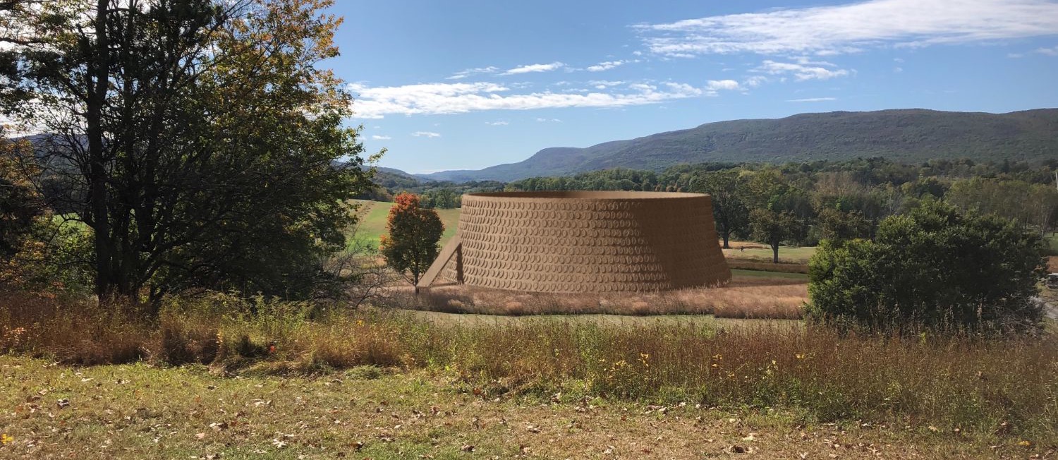 Render of the MASS BODY pavilion: a circular ceramic-tiled shell with an entry ramp, set in an autumn meadow before wooded mountains